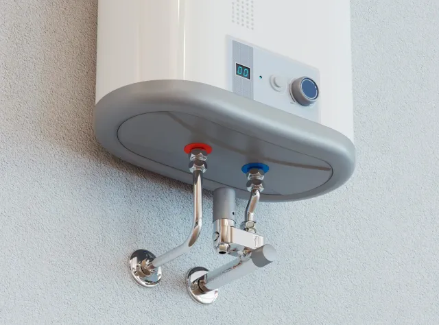 Wall-mounted water heater with red and blue pipe connections and control dial.